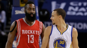 Golden State Warriors guard Stephen Curry (30) smiles next to Houston Rockets guard James Harden (13) during the first half of an NBA basketball game in Oakland, Calif., Wednesday, Jan. 21, 2015. (AP Photo/Jeff Chiu)